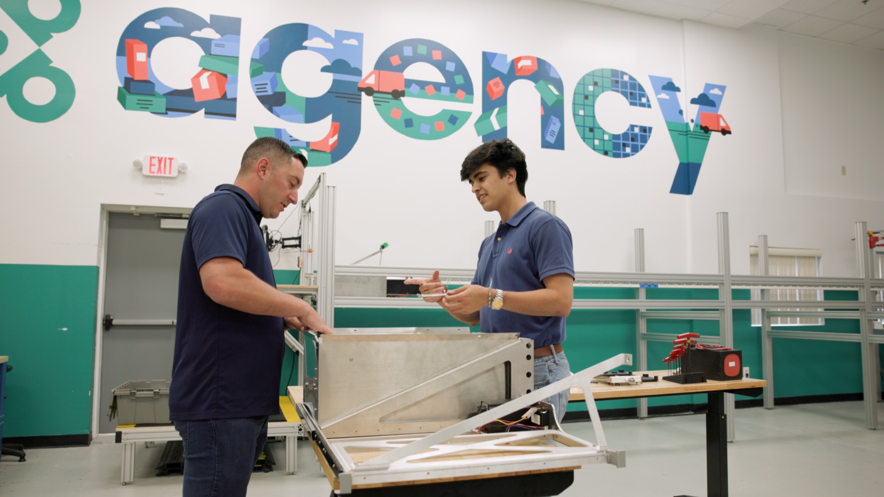 Agency Robotics engineers assembling a sortation prototype in the Woburn workshop